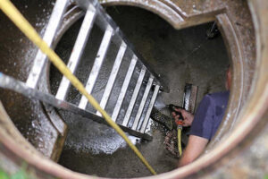 man in septic tank cleaning whangarei site